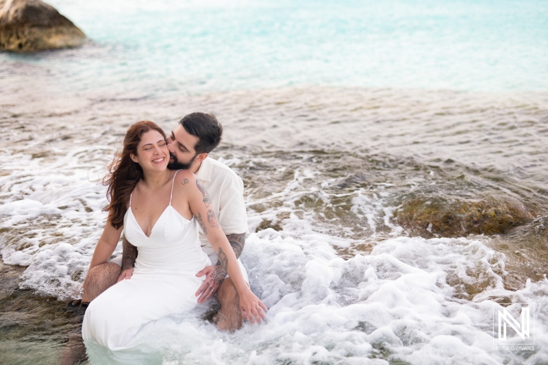 Couple enjoys a romantic trash the dress session at Cas Abao Beach in Curacao with gentle waves and scenic beauty