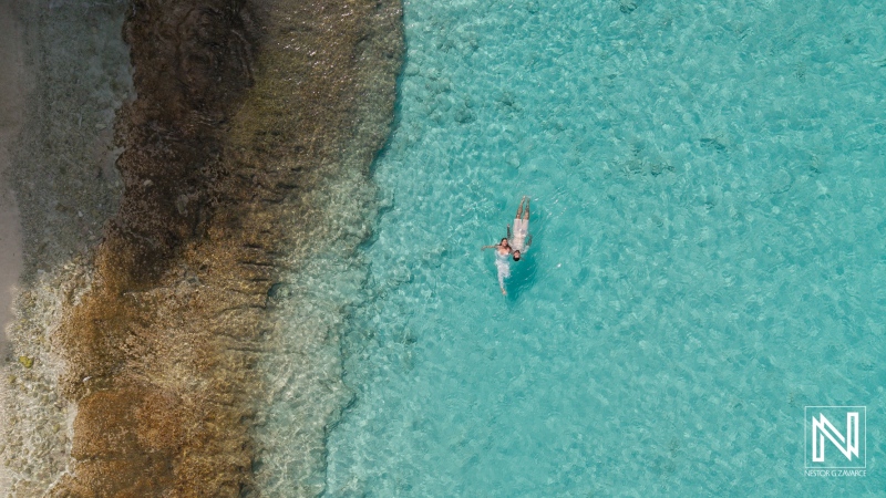 Floating in turquoise waters at Cas Abao Beach during a Trash the Dress session in Curacao