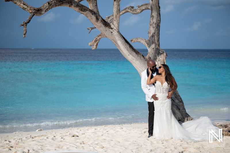 Couple enjoys trash the dress photoshoot at a beach in Curacao during sunny weather