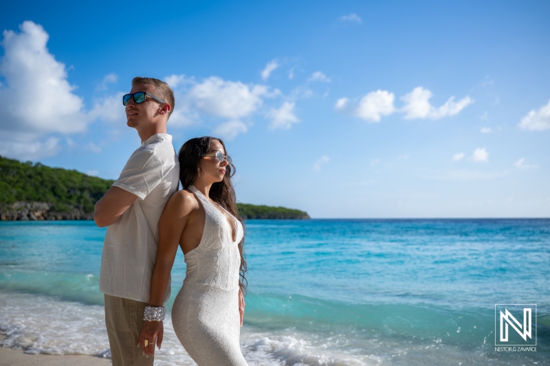 Couple enjoys a trash the dress photoshoot at Cas Abao Beach in Curacao on a sunny day with clear blue water