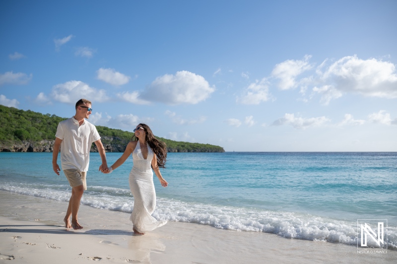 Couple enjoys a fun trash the dress photoshoot at Cas Abao Beach in Curacao on a sunny day