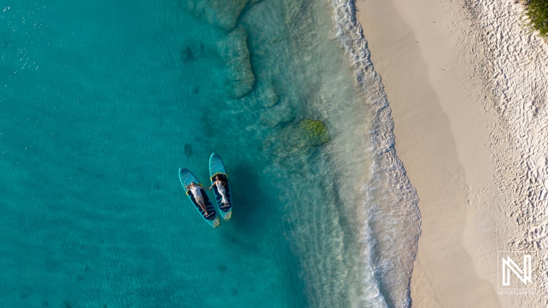 Trash the dress photoshoot at Cas Abao Beach in Curacao with a couple on a boat in clear water