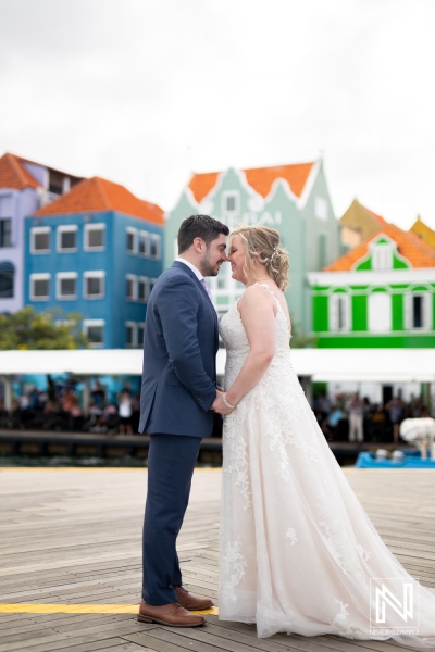 Beautiful couple enjoys trash the dress session in Curacao against a backdrop of vibrant colorful buildings