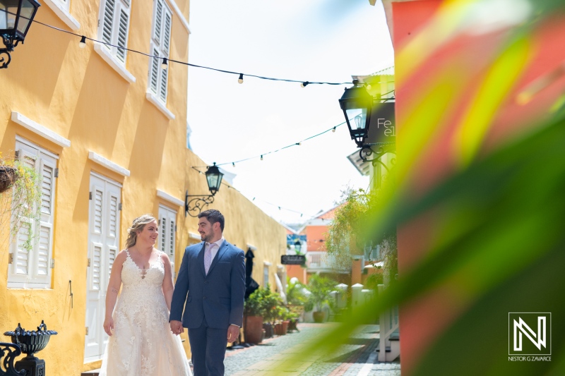 Couple enjoys a romantic stroll in colorful streets of Curacao during their Trash the Dress session