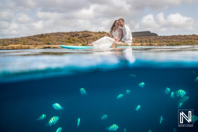 Underwater experience in Curacao with couple and colorful fish in clear water