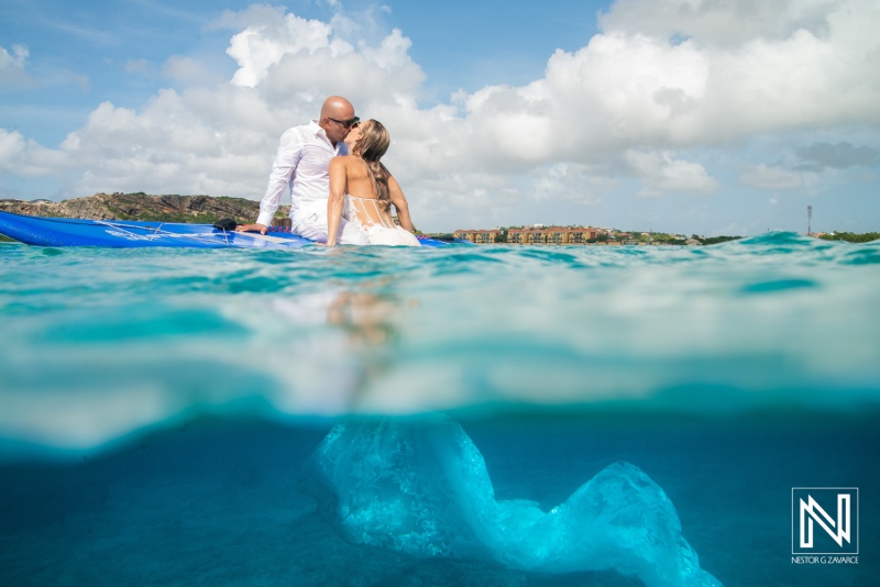 Underwater moment in Curacao with couple on paddleboard