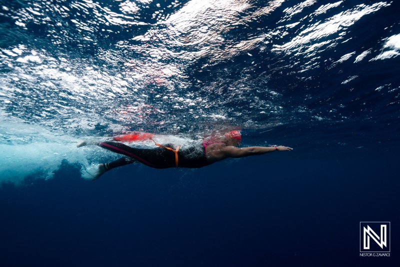 Underwater swimmer enjoying the waters of Curacao during a sunny day
