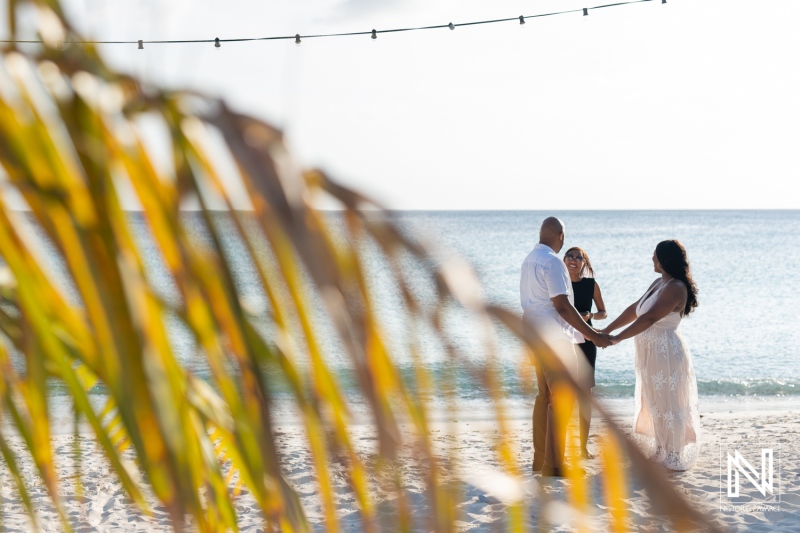 Renewing vows on a beautiful beach in Curacao while revealing exciting pregnancy news with heartfelt emotions and joyful laughter