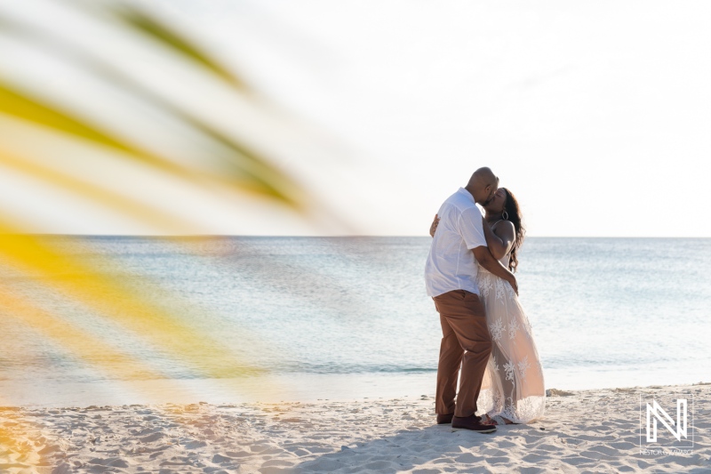 Couple celebrates vow renewal and announces pregnancy on a picturesque beach in Curacao during golden hour