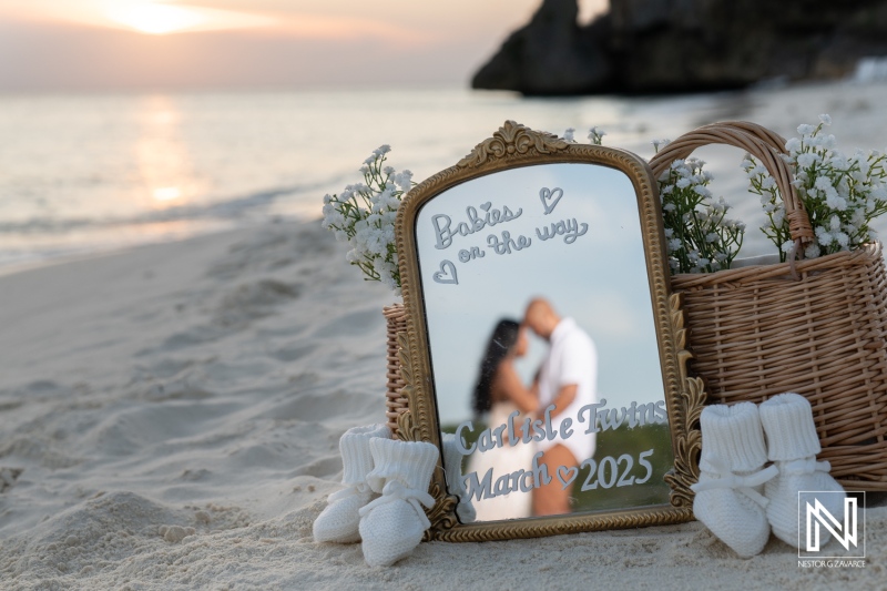 Couple celebrates vow renewal and pregnancy reveal on the beach in Curacao at sunset