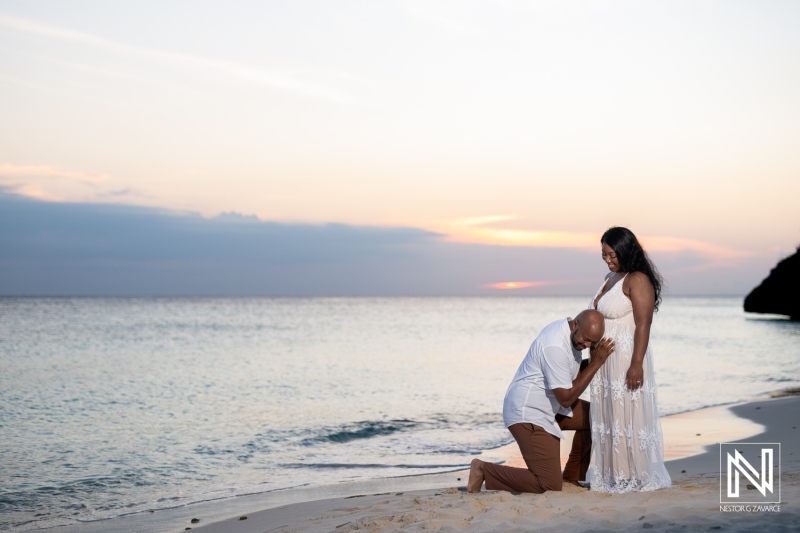 Vow renewal ceremony at sunset on the beach in Curacao with a pregnancy reveal