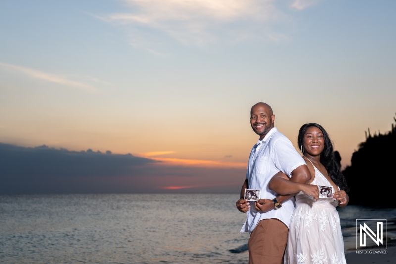 Couples vow renewal and pregnancy reveal in Curacao with sunset as a backdrop