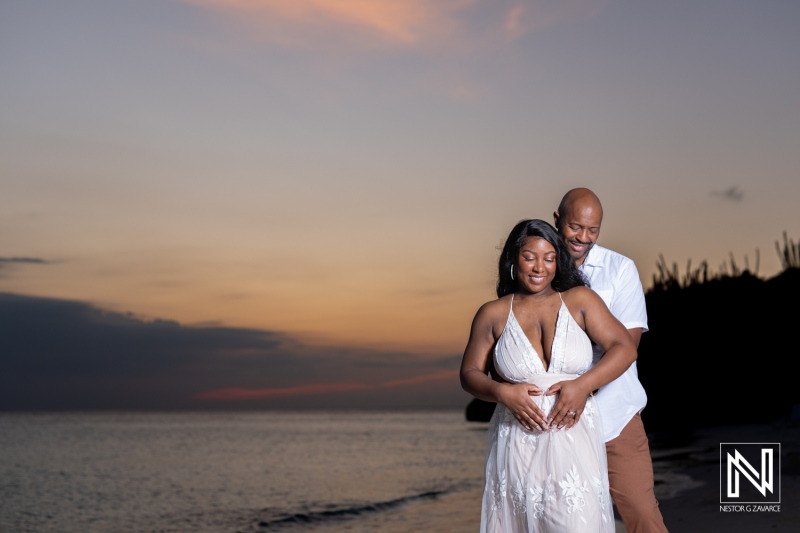 Couple celebrates vow renewal and pregnancy reveal on the stunning beaches of Curacao at sunset