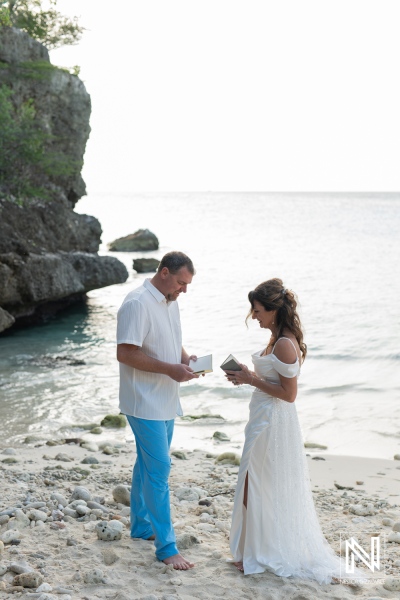 Couple renews their vows on a beautiful beach in Curacao during a serene evening ceremony with a stunning ocean backdrop