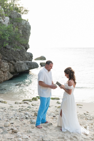 Couple renews their vows on a serene Curacao beach at sunset, surrounded by natural beauty and intimate moments of love