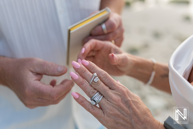 Vow renewal ceremony in Curacao highlights love, commitment, and beautiful rings under the sun on a sandy beach