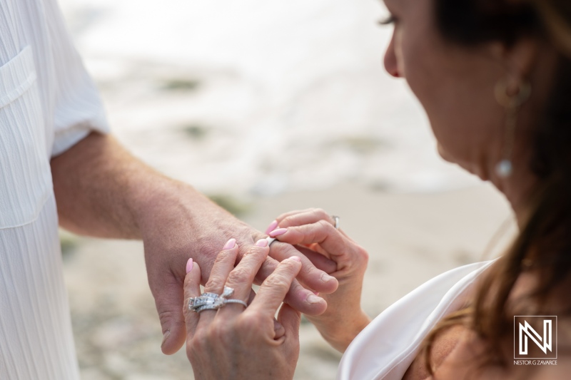 Couple renewing their vows on the beach in Curacao during a romantic sunset ceremony celebrating their love and commitment