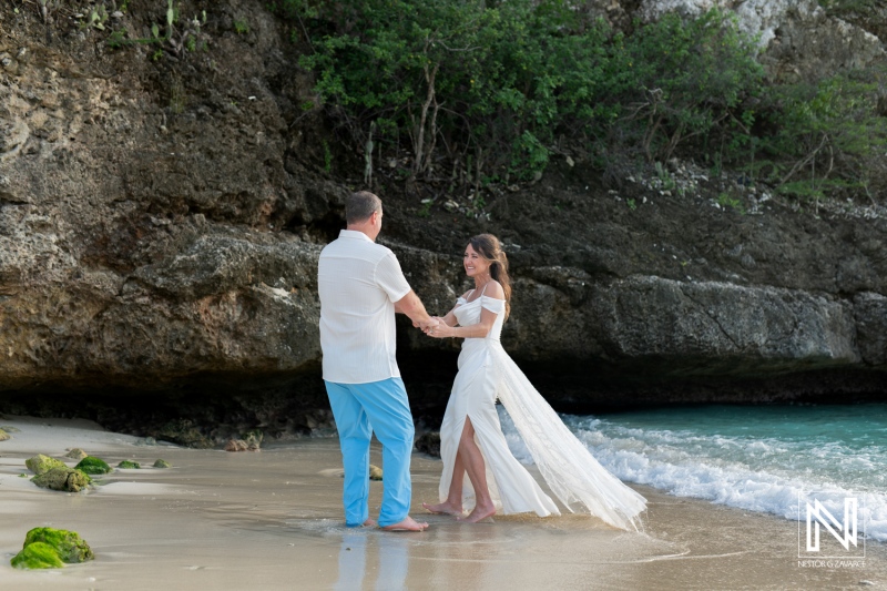 Vow renewal ceremony on the picturesque beach of Curacao during sunset with a joyful couple celebrating their love