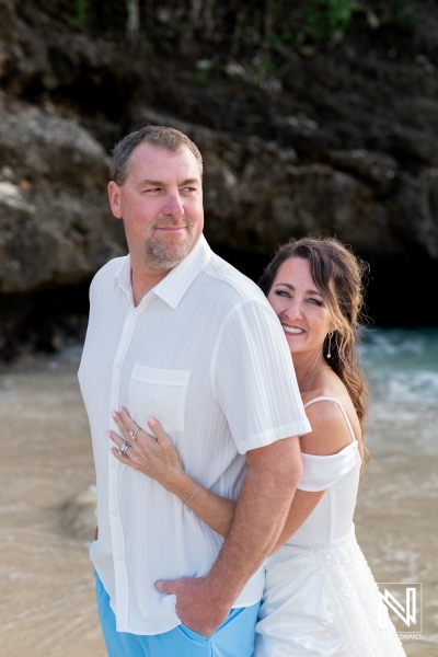 Vow renewal ceremony on the beach in Curacao with joyful couple embracing on the shore