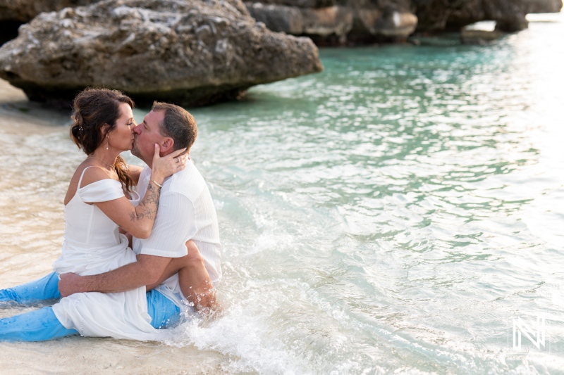 Vow renewal ceremony in Curacao by the beach with couple embracing near water