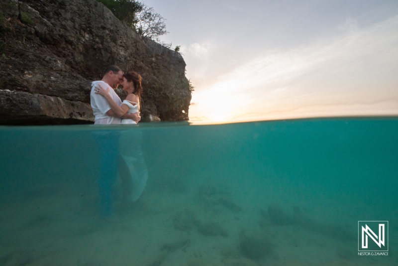 Vow renewal ceremony in Curacao at sunset with couple embracing in the water