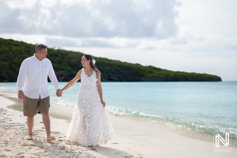 Couples walk hand in hand along Cas Abao Beach while celebrating their vow renewal in Curacao surrounded by natural beauty and serene waters