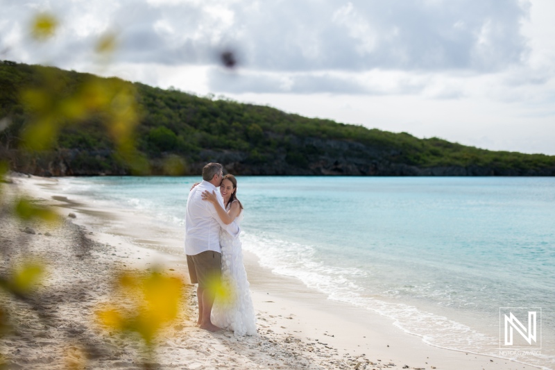 Couple renews vows on the serene shores of Cas Abao Beach in Curacao under a cloudy sky