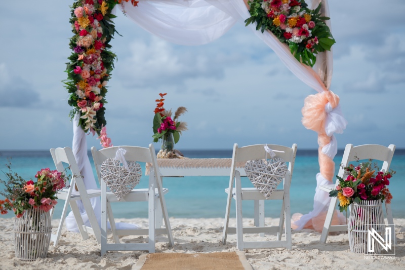 Vow renewal ceremony setup at Cas Abao Beach in Curacao with floral decorations and seating arrangements