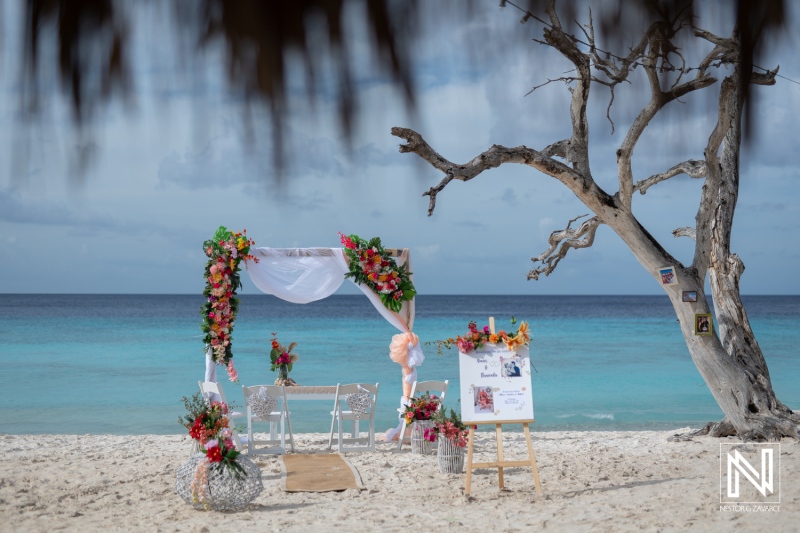 Vow renewal ceremony at Cas Abao Beach in Curacao with floral decorations and a stunning ocean backdrop
