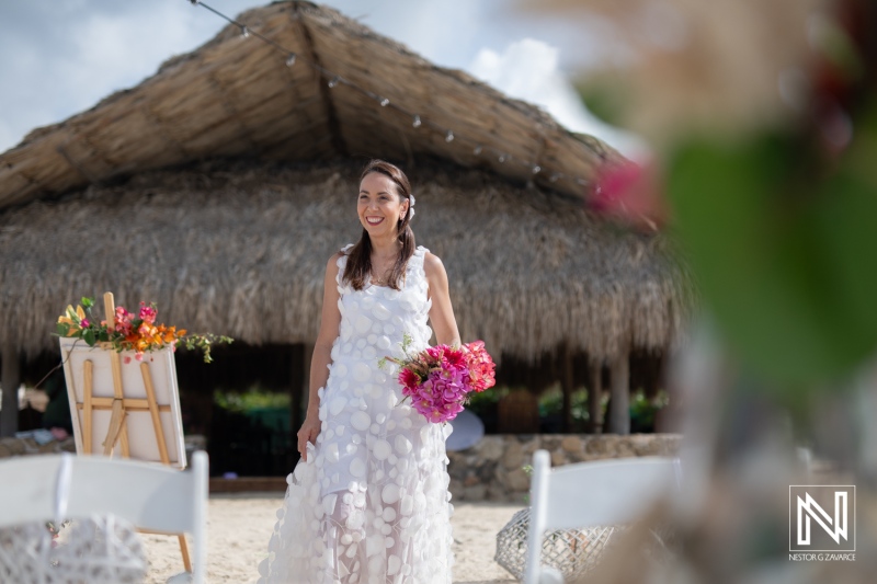 Renewal of vows ceremony at Cas Abao Beach in Curacao with beautiful floral arrangements and elegant attire