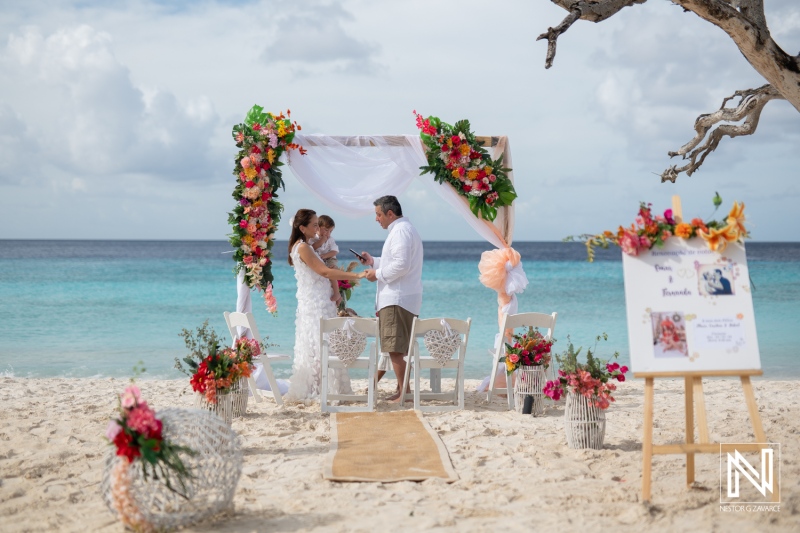 Couple renews vows on the stunning Cas Abao Beach in Curacao surrounded by tropical flowers and crystal clear waters