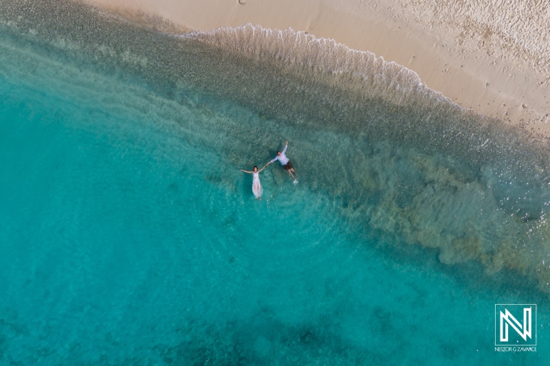 Vow renewal celebration at Cas Abao Beach in Curacao with a couple enjoying the serene turquoise waters