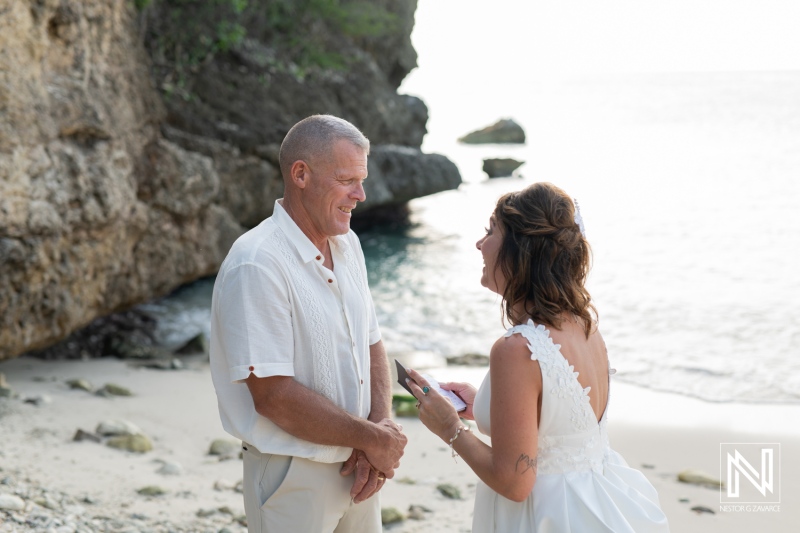 Couple joyfully renewing their vows on a picturesque Curacao beach during sunset, surrounded by stunning natural beauty and love