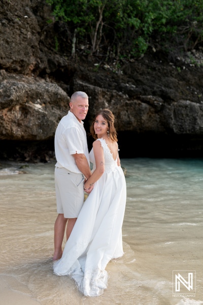 Couple celebrates vow renewal on the beautiful beaches of Curacao during a romantic sunset ceremony