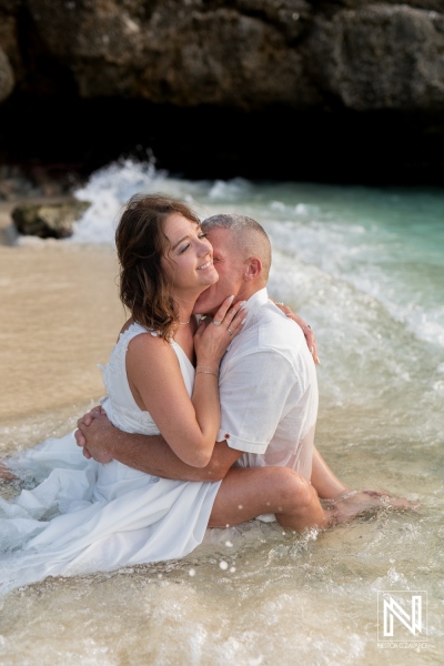 Couple enjoys a romantic vow renewal on the stunning beaches of Curacao under the soft waves and tropical sun