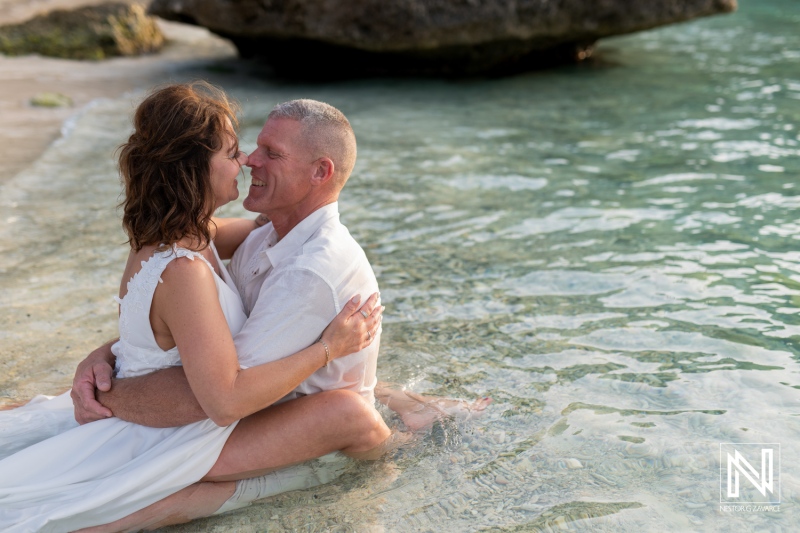 Couple engages in romantic vow renewal ceremony on the beautiful shore of Curacao during sunset
