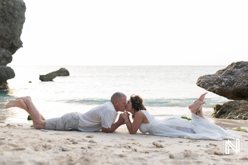 Couple celebrates vow renewal on the beach in Curacao during sunset with intimate kiss and romantic ambiance