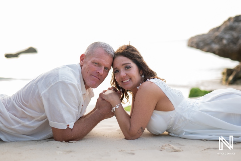 Couple celebrates vow renewal on the beach in Curacao during a romantic sunset ceremony