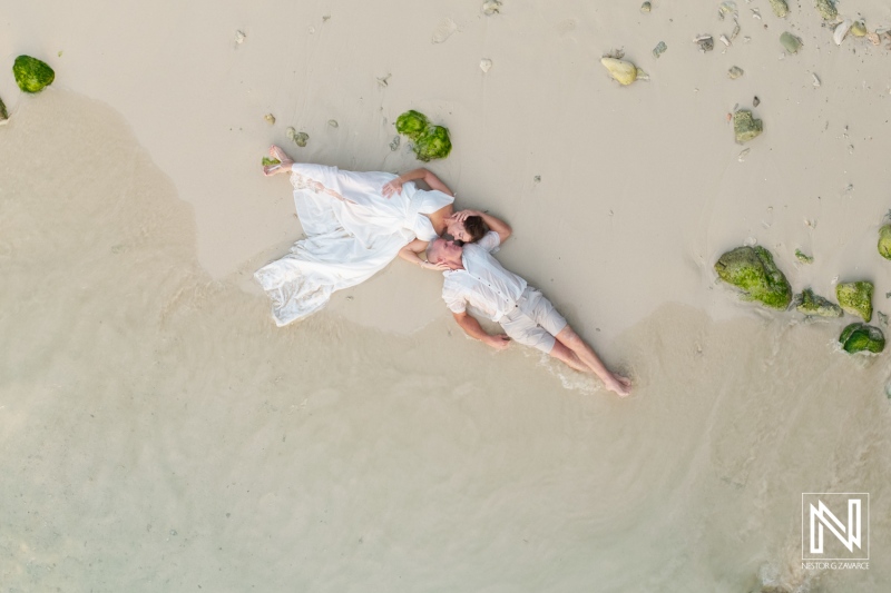 Couple celebrating a vow renewal on the picturesque shores of Curacao during a serene beach moment