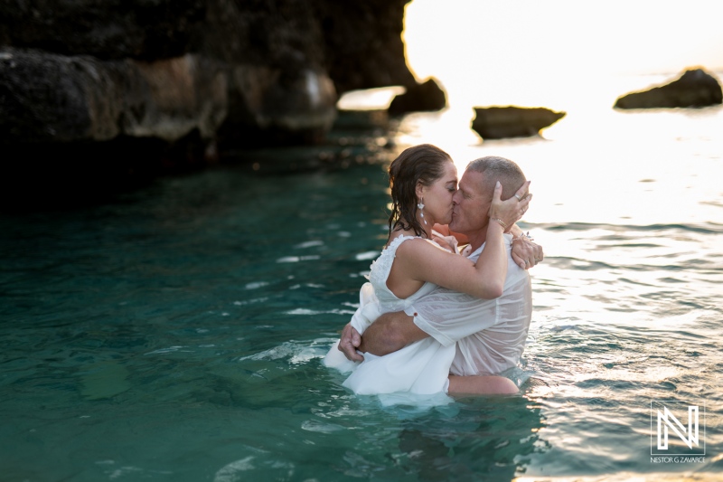 Couple celebrates vow renewal in the clear waters of Curacao at sunset