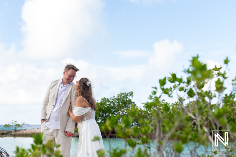 Couple celebrates vow renewal at Doggy Beach in Curacao under clear skies and turquoise waters