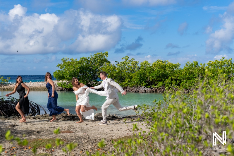 Vow renewal ceremony at Doggy Beach in Curacao with joyful celebration by friends