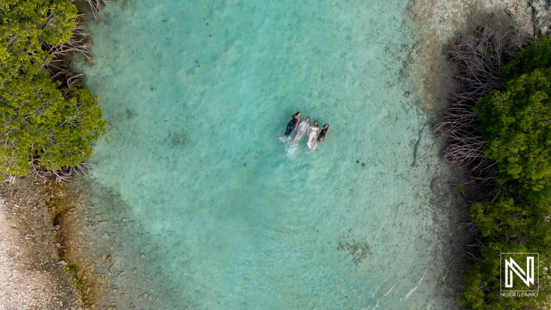 Couples celebrate their vow renewal at Doggy Beach in Curacao amidst serene waters and lush greenery