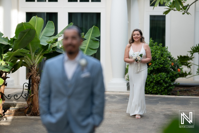 A Joyful Bride Approaches Her Groom in a Lush Garden Setting, Capturing a Heartfelt Moment on Their Wedding Day Amidst Vibrant Greenery