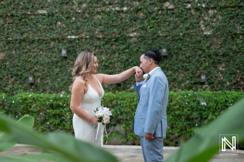 A Joyful Couple Enjoys a Romantic Moment During Their Outdoor Wedding Ceremony Surrounded by Lush Greenery in a Tranquil Garden Setting