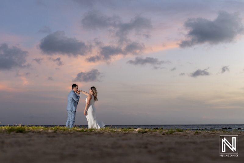 A Couple Enjoys a Romantic Moment on the Beach at Sunset, Capturing Their Special Day Against a Vibrant Sky With Gentle Waves in the Background