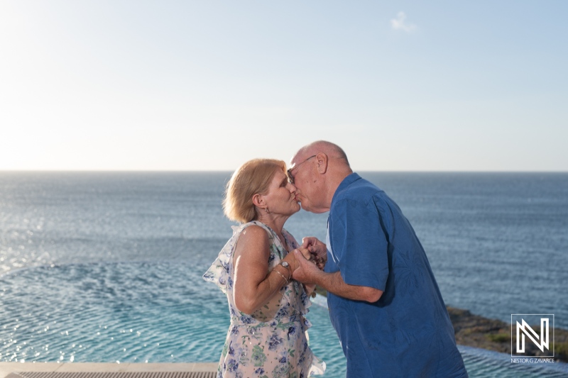 An Elderly Couple Shares a Tender Kiss by the Ocean During Sunset, Capturing a Moment of Love and Connection at a Seaside Resort