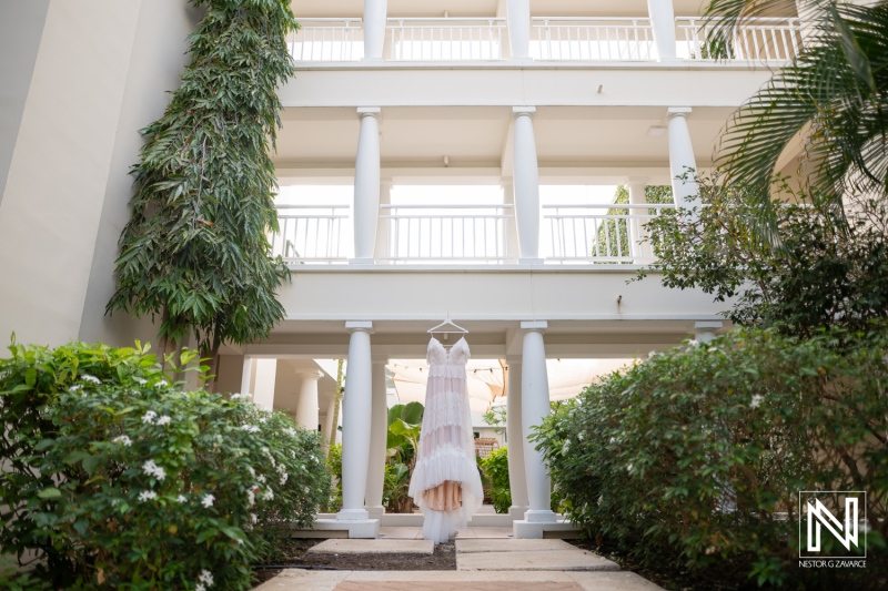 Vow renewal ceremony takes place at Curacao Marriott Beach Resort with wedding dress displayed