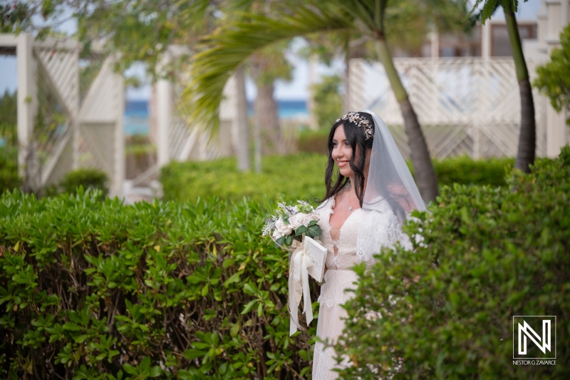 Vow renewal ceremony at Curacao Marriott Beach Resort with bride walking amid greenery