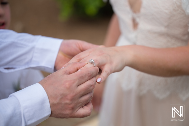 Couple exchanges rings during their vow renewal ceremony at Curacao Marriott Beach Resort